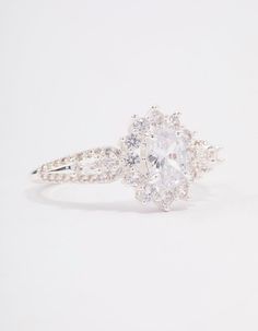 an oval cut diamond ring with two side stones