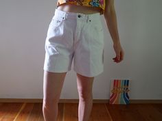 "White wash denim shorts really make a Summer tan pop! Color: White Fabric: 100% cotton on stretch denim Brand: Navy Blue Clothing Company (estimated 1990s era vintage retro jean shorts) Bermuda length Zipper and Single Button Closure Flaws: some wear on the inside thigh seam - item is in good vintage condition for an estimated 90s era piece. About the Fit: Model is 5,7\" and usually wears a modern women's size S - M / 28 / US 4 - 6. The shorts are tight on the model please see the measurements Y2k High Rise Cotton Shorts, Y2k High Waist Cotton Shorts, Y2k Style Cotton Shorts For Spring, Spring Y2k Style Cotton Shorts, Spring Y2k Cotton Shorts, White 90s Style Shorts For Summer, White 90s Style Summer Shorts, Cotton Y2k Shorts For Summer, Summer Cotton Y2k Shorts