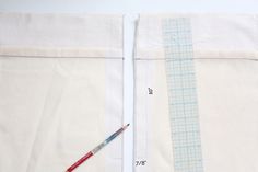 two pieces of fabric are next to each other with a needle and thread on them