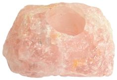 a pink rock sitting on top of a white surface