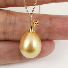 Lovely In-House designed solid 14K yellow gold pendant with an organic natural color, south sea cultured pearl from Australia. The huge size, genuine seawater pearl exhibits a high luster, thick nacre & smooth surface with minor natural spots; kindly refer to the pictures of the actual pendant for detail. ※ The CHAIN is for display purpose only. It doesn't come with the pendant.   Style: Pendant Precious Metal: Solid 14k yellow gold   Pearl Origin: Broome; Western Australia. Pearl Type: South Sea Cultured Pearl Main Color: Golden. Treatment: None. 100% organic natural color. Pearl Shape: Drop. Pearl Size: 13.4 x 17.0mm. Luster: High. Nacre: Thick. Surface: Smooth with minor natural spots/blemishes. Pendant total length (approx.): 2.7cm / 1.0 inch. Place of Manufacture: Hong Kong. REMARKS: Yellow Gold Pear-shaped Pearl Necklace With High Luster, Yellow Gold Pear-shaped High Luster Pearl Necklace, Pear-shaped High Luster Yellow Gold Pearl Necklace, Broome Western Australia, South Seas, Pearl Types, Yellow Gold Pendants, Precious Metal, Pearl Size