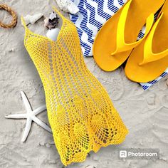 there is a yellow netted bag on the beach next to sandals and starfish