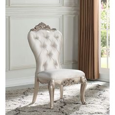 a white chair sitting on top of a rug