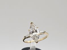 an engagement ring with two baguettes on it and a diamond in the middle