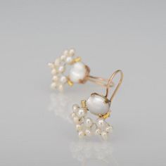 These handcrafted fan earrings are delicate, sparkling and whimsical. The unique copper bezel setting showcases the mother of pearl and beautiful hand-woven freshwater pearl underneath.These unique fan earrings seem to come straight from a fairy tale!The hook is gold filled.Measurements:Total length from top to bottom: approx. 2.6 cmWidth: 1.8cmA matching pearl necklace available here: https://etsy.me/3n76jRfSince I use natural gemstones, each jewel is unique and therefore there are subtle diffe Wedding Earrings Pearl, Pearl Bridal Earrings, Pearl Cluster Earrings, Pearl Earrings Wedding, Pearl Jewelry Wedding, Bridal Earrings Pearl, Pearl Bridal, Fan Earrings, Pearl Cluster