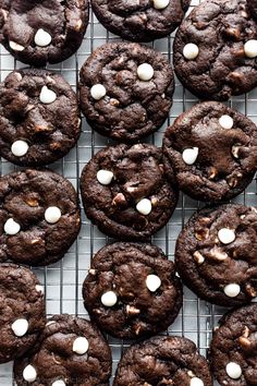 chocolate cookies with marshmallows are on a cooling rack and ready to be eaten