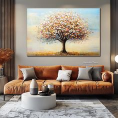 a living room filled with furniture and a large painting on the wall above it's couch