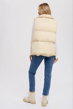 Stay warm and stylish with our Sandstone Puffer Vest. Featuring a trendy padded design, denim layered button-up front, and high collar, this vest adds a touch of edge to any outfit. With a relaxed fit and zip-up closure, it's perfect for layering. Casual Winter Vest Outerwear, Casual Winter Vest, Cotton Vest For Cold Weather/winter, Winter Cotton Vest For Cold Weather, Trendy Cotton Vest Outerwear, Casual Cold Weather Outerwear Vest, Winter Cotton Vest Outerwear, Beige Cotton Vest Outerwear, Cotton Vest Outerwear For Cold Weather