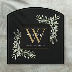 a black and gold monogrammed sign with the letter w on it's side