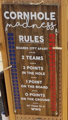 a sign that is on the side of a wooden board with rules and numbers written in red, white and blue