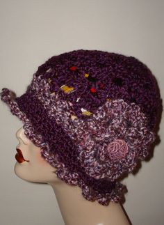 a crocheted hat on top of a mannequin's head with buttons