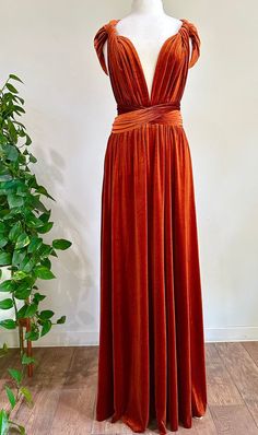 "BURNT ORANGE VELVET Convertible Dress ❤ ❤ SIZING & DRESS MEASUREMENTS : ❤ ❤ ONE SIZE FITS MOST: - Waist circumference from 24 inches to 44 inches Maximum stretchiness. Fits sizes 0-16. Length: Floor LENGTH : from Waistline to Bottom: 45 inches. ❤❤ FREE Matching Bandeau❤❤ Material: ~ Stretch Velvet ~ 4 Way Stretch ~ Unhemmed bottom so there is no bulging and it hangs effortlessly. ~ Elastic Banded Waist for a secure fit. ~ The adjustable straps measure 85\" in length each to create endless style Rust Gown Burnt Orange, Multi-way Bridesmaid Dresses, Velvet Bridesmaids Dress, Burnt Orange Velvet, Infinity Dress Bridesmaid, Multiway Dress, Dress Bridesmaids, Multi Way Dress, Velvet Bridesmaid Dresses