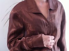 Vintage shiny brown shirt. 90's sheen brown bronze blouse. Fits like a M. Made in spain. Measurements lying flat: Bust: Waist: Length: Very good condition. Metallic Sheen Blouse For Fall, Formal Brown Button-up Top, Brown Silk Party Tops, Party Brown Silk Tops, Spring Brown Silk Blouse, Brown Silk Tops For Fall, Brown Silk Blouse For Spring, Fitted Brown Shirt For Formal Occasions, Vintage Brown Party Top