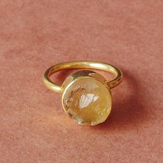 For every November born who desire the gift of protection and strength, this natural citrine ring is a design which proves to be a dream come true. The birthstone comes in a delicate stackable design which leaves no room for any fashion compromise for the wearer making this an ideal gift choice.  Elegant 18K Yellow Gold Plated Natural Raw Citrine Brass Stone Ring, Round Stone Stacking Ring, Unique Birthstone Ring For Women Product Details Item Code: BJBR-1743 Stone Name: Citrine Stone Size: 10 mm Metal: 18K Yellow Gold Plated Over Brass Ring Sizes: Please choose from drop down menu. If you do not see your finger size, select custom and I'll make a ring just for you!  Note:- These rings you will receive may vary slightly in color from the images because these are natural gemstones and vary Dainty Citrine Round Jewelry, Dainty Round Citrine Jewelry, Gold Oval Crystal Ring, Stackable, Gold Oval Stackable Crystal Ring, Gold Oval Crystal Ring Stackable, Gold Crystal Ring With Topaz Birthstone, Dainty Citrine Jewelry, Citrine Gemstone Crystal Promise Ring, Citrine Birthstone Crystal Ring Fine Jewelry