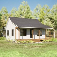 a small white house sitting on top of a lush green field in front of trees