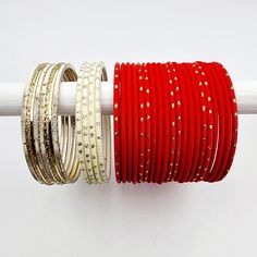 Embrace the bold and beautiful with our Samina Bangle Set! Featuring a striking matte red reminiscent of your favorite lipstick, framed by lustrous pearls and light platinum gold with a touch of golden glitter. A fabulous addition to your collection. Luxury Red Hand Set Bangle, Red Bangles Set, Cheap Red Festive Bangle, Luxury Red Bangle, Luxury Red Festive Bangle, Heavy Red Bangle, Golden Glitter, Matte Red, Bangle Set