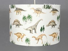 a lamp shade with dinosaurs on it