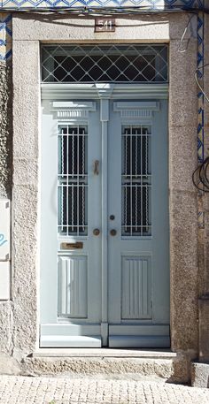 two blue doors on the side of a building