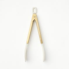 an open pair of scissors on a white background with clippings in the middle