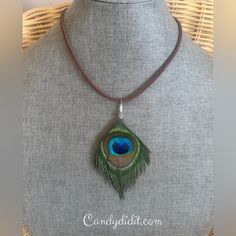 a necklace with a peacock feather on it