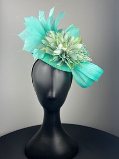 An aqua button base with beautiful aqua abaca silk, an aqua and pale green hydrangea, with aqua feather crown. Sits on a comfortable pale green headband. Lightweight and easy to wear. Ships in a high quality storage box. One of a kind.  Perfect for Kentucky Derby, Royal Ascot, church, weddings, just for fun. Green Feathered Headpiece For Weddings, Green Summer Fascinator With Handmade Flowers, Summer Green Feathered Headpiece, Elegant Green Feathered Headpieces, Turquoise Fascinator For Spring Wedding, Elegant Turquoise Headpiece For Wedding, Elegant Turquoise Wedding Headpiece, Turquoise Headpieces For Spring Weddings, Spring Wedding Turquoise Headpieces