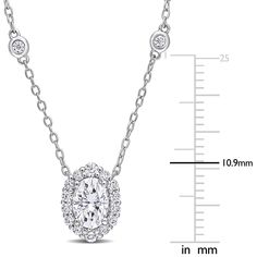 Indulge in the decadence of this round moissanite pendant. Disco-ball dazzle sets the gemstone necklace apart in sterling silver. With the enduring qualities of moissanite, a round center stone enjoys a dainty halo for magnified glamour. An 18-inch sterling silver cable chain features two bezel-set lab-created moissanite gemstones with a hidden bale for a visually seamless look. The total diamond equivalent weight is approximately 1 1/2 carats. | Moissanite Oval Halo Pendant Necklace | Sterling Oval Diamond Pendant Necklace With Accents For Anniversary, Oval Diamond Pendant Necklace For Anniversary, Oval Pendant Diamond Necklace With Accents For Anniversary, Oval Halo Setting Necklace For Formal Occasions, Anniversary Fine Jewelry Diamond Necklace With Oval Pendant, Anniversary Oval Pendant Diamond Necklace, Classic Oval Pendant Necklace With Halo Design, Formal Oval Pendant Necklace With Diamond Accents, Timeless Cubic Zirconia Oval Pendant Necklace