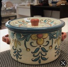 an ornately decorated casserole sitting on top of a table in a room