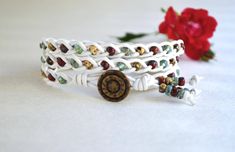 Braided Three Wrap Bracelet, Multicolor Picasso Beads on White Leather. The bracelet is made with picasso beads, braided onto white leather. Button on one end and loop on the other end of bracelet provide closure. The bracelet is 21.5'' long.  Please, let me know if you need another length. The bracelet is lightweight and easy to wear. It will compliment owner's look and outfit. Compliments guaranteed. This Handcrafted piece is a priceless addition to handmade jewelry collection. Awesome gift for someone very special as well If you have any questions please contact me. Other unique wrap bracelets https://www.etsy.com/shop/JewelryByYevga?ref=hdr_shop_menu&section_id=15478050 All JewelryByYevga shop https://www.etsy.com/shop/JewelryByYevga?ref=hdr_shop_menu Leather Beaded Bracelet, Beaded Leather Bracelet, Native American Bracelets, Decorative Beads, Bracelet Boho, Bracelet Beaded, Bead Leather, Braided Bracelets, Braided Leather