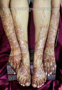 two women with henna tattoos on their feet