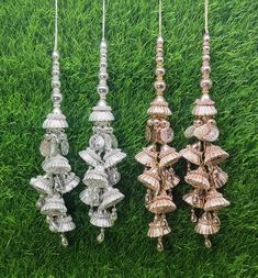 three silver and gold colored chandeliers hanging on green grass