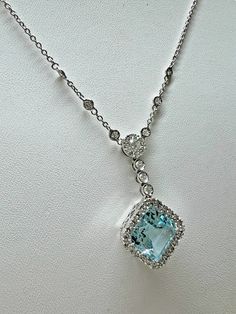 "Favero 18kt gold, diamond and aquamarine necklace. The aquamarine is approximately a 4.00ct modified square cut. Surrounded and continuing up the rolo chain are diamonds with an approximate weight of 0.51ctw. The diamonds are of F color and VS clarity. This necklace was sold new for 5,000 and is in like new condition. The necklace is 16\" long.   ------------------------------------------------------ Specification: ------------------------------------------------------   Category Style: Chain      Brand: Favero   Metal Purity: 18k Base Metal: White Gold      Main Stone: Aquamarine Main Stone Color: Aqua Main Stone Shape: Modified Square     Secondary Stone: Diamond        Internal ID: 30077" Elegant Aquamarine Necklace For Formal Occasions, Luxury Light Blue Brilliant Cut Jewelry, Luxury Aquamarine Necklace For Formal Occasions, Formal White Gold Aquamarine Necklace, Elegant Diamond White Aquamarine Jewelry, Luxury Aquamarine Pendant Necklace, Light Blue Aquamarine Jewelry With Diamond Accents, Formal Light Blue Aquamarine Necklace, Light Blue Fine Jewelry Necklace For Formal Occasions