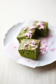 two pieces of green cake sitting on top of a white plate