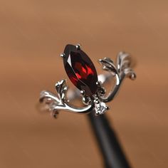 It is a garnet ring. The main stone is 5 mm* 10 mm marquise cut. weight about 1.35 carats. The basic metal is sterling silver and plated with rhodium. To change the metal to a solid gold (white/rose) or platinum is also available, please ask for a quotation if you want. You can also go to my shop Home for more elegant rings: https://www.etsy.com/shop/godjewelry?ref=hdr_shop_menu Alexandrite is June birthstone More alexandrite rings: https://www.etsy.com/shop/godjewelry?ref=seller-platform-mcnav& Ruby Wedding Rings Silver, Garnet Engagement Ring Silver, Ruby Engagement Ring Silver, Ruby Ring Silver, Alexandrite Rings, Nontraditional Engagement Rings, Gothic Wedding Rings, Elegant Rings, Garnet Ring Silver