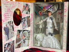 a barbie doll in a wedding dress and hat inside a box with photos on it