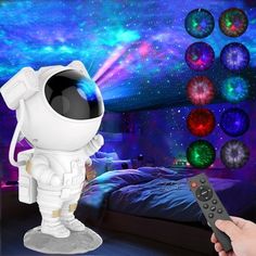 a person holding a remote control in front of an image of a bedroom with colorful balls on the wall