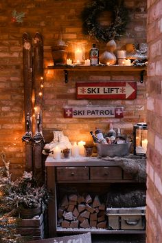 there is a ski lift sign on the wall next to a table with candles and other items