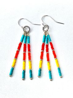 two pairs of colorful beaded earrings on white background