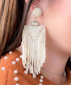 Introducing our Tassel Queen Earrings, a testament to opulent style and meticulous artistry. These earrings exude an air of elegance and grace, adorned with a lavish arrangement of ivory seed beads that come together in perfect harmony.
Embrace your inner royalty as you don the Tassel Queen Earrings, where every detail reflects a commitment to luxurious design. The ivory seed beads delicately shimmer, creating an ethereal and timeless aura that captures the light and draws attention. The tassels Elegant Beaded Dangle Earrings With Tassels, Elegant Beaded Fringe Earrings, Elegant Beaded Fringe Chandelier Earrings, Bohemian White Beaded Earrings, Elegant Beaded Fringe Jewelry, Natural Beaded Dangle Jewelry, White Pearl Beaded Bohemian Earrings, Natural Color Beaded Dangle Jewelry, Bohemian White Pearl Beaded Earrings