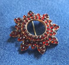 Antique 9 Karat Gold Garnet Victorian Brooch Pin / This amazing piece is covered with faceted garnets around a circle center.  There is a stamp of some kind on the back side, but it is too small to make out for me. Excellent condition!  Clasp works well. 2.5 inches across. In excellent antique condition.  We sell select vintage items. They are not new, and rarely look new. They are, in many cases, older than we are.  They have seen life and times. We do not repair or replace parts on any of the Victorian Brooch, A Circle, Packing Material, Glass Blowing, Brooch Pin, Brooches, Garnet, Vintage Items, Etsy Accessories