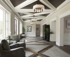 a living room filled with lots of furniture and windows