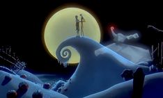 two people standing on top of a snow covered hill in front of a full moon