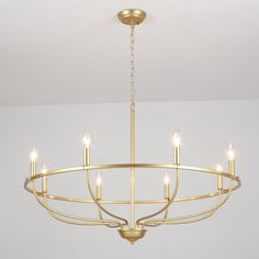 a chandelier with six lights hanging from it's center point in a room