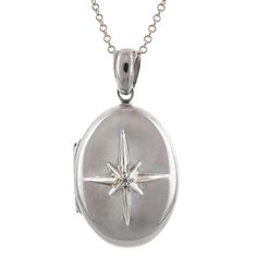 Centering an eight point star set with a Round Brilliant cut diamond weighing approx. 0.02ct, on a Sterling Silver of 18k yellow gold & Sterling Silver locket measuring approx. 1 1/8 x 5/8 inch. Suspended from a Sterling Silver chain 16 inches. Oval Locket Necklace Silver, Star Locket Necklace, Silver Locket Aesthetic, Silver Medallion Necklace With Single Cut Diamonds, Timeless Silver Locket Jewelry, Silver Star-shaped Jewelry With Single Cut Diamonds, Formal White Gold Star Of David Jewelry, Classic Silver Star-shaped Jewelry, Antique Silver Jewelry With Compass Design