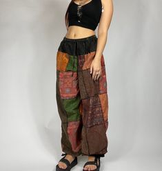 Bohemian mixed patchwork hippie pants in black/ mixed color patches. Each pair is slightly unique and will have some different patches and colorings! Waist stretches from 24-35' inches comfortably. Model is 5'2 for reference. Measurements: Inseam: 31’ Waist: 24’ to 35’ Patchwork Pants Outfit, Patchwork Hippie Pants, Hippie Style Outfits, Patched Pants, Cottagecore Pants, Goblincore Clothes, Bohemian Chic Outfits, Rustic Outfits, Black Hippy