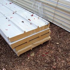 several stacks of wooden planks laying on the ground