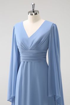 a dress on a mannequin with a blue top and long sleeved sleeves