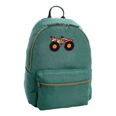 a green backpack with an image of a monster truck on the front and back pocket