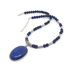 Handmade Lapis Lazuli Beaded Boho Necklace With Large Oval Pendant Made with natural dyed Lapis Lazuli 6 mm round beads and 1 x 0.8 mm barrel beads Tibetan silver spacer beads  Tibetan silver filigree bail Strong silicon-coated steel beading wire Large oval Lapis Lazuli cabochon pendant, size 4 x 3.2 x 0.6 cm (1.57 x 1.25 x 0.23 inches), framed in silver plated metal bezel Silver-plated brass findings Strand length 18 inches ( 45 cm ) + 2 inches extension chain Product Safety Information * Check Bohemian Oval Beaded Necklaces, Bohemian Oval Beaded Necklace, Oval Beaded Spiritual Necklaces, Spiritual Beaded Oval Necklace, Bohemian Oval Gemstone Bead Necklaces, Handmade Oval Lapis Lazuli Necklace, Bohemian Oval Gemstone Beads Necklace, Spiritual Oval Beaded Necklace, Adjustable Oval Necklace With Gemstone Beads