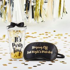 a black and gold party bag next to a sippy cup that says it's party time