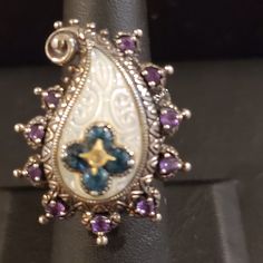 Carved Mop Is Surrounded By Amethysts. In The Center Is The Iconic Bixby Flower In Blue Topaz With A Touch Of 18k In The Center. Like-New Condition. This Item Is From My Personal Collection. I Purchased It New. Barbara Bixby Rings, 6 Rings, Ring Color, Womens Jewelry Rings, Blue Topaz, Topaz, Paisley, Amethyst, Carving